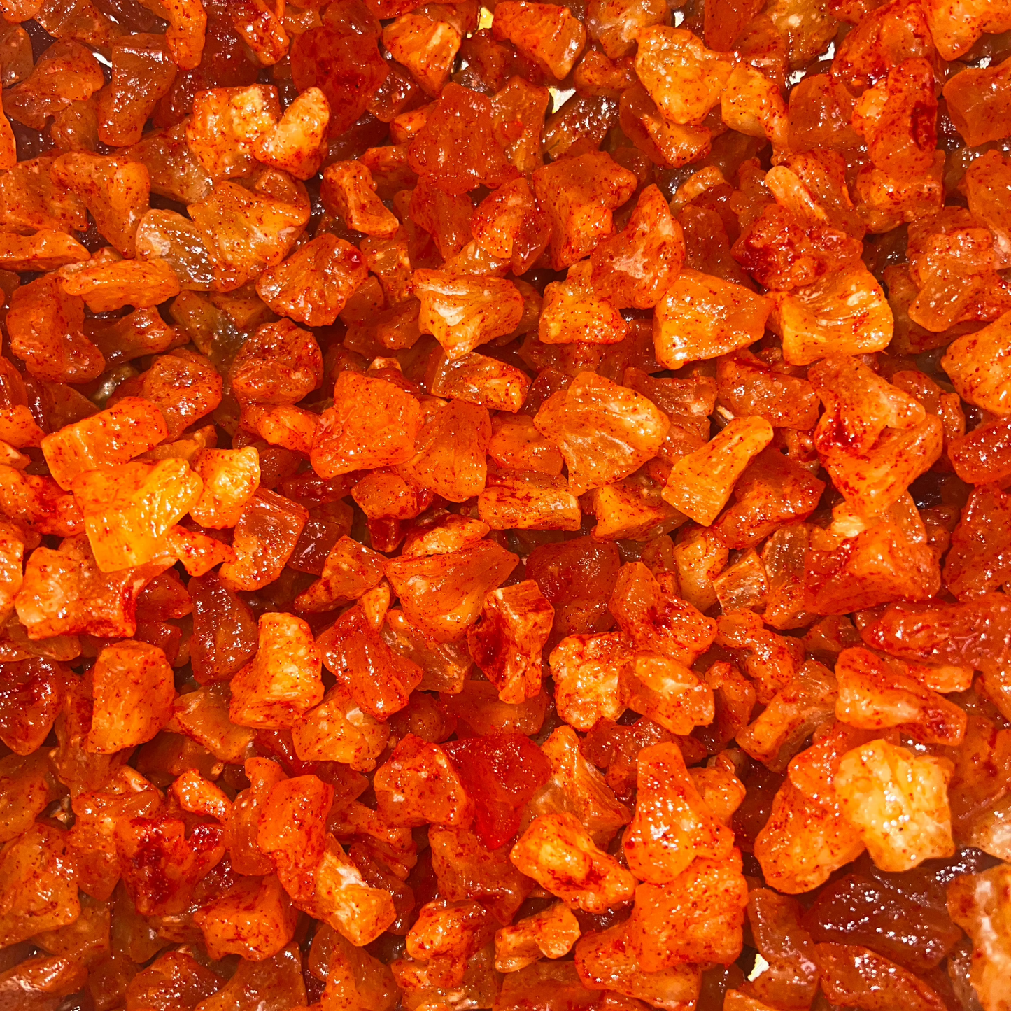 A close-up image of Li Hing Mui dried pineapple, showing the texture and color of the dried pieces.