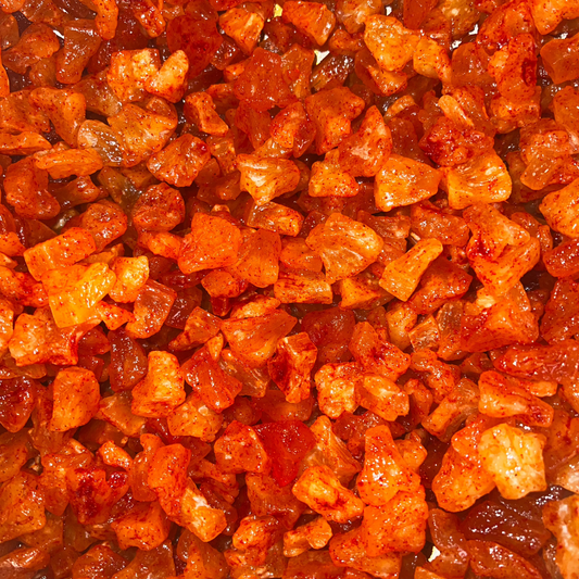 A close-up image of Li Hing Mui dried pineapple, showing the texture and color of the dried pieces.