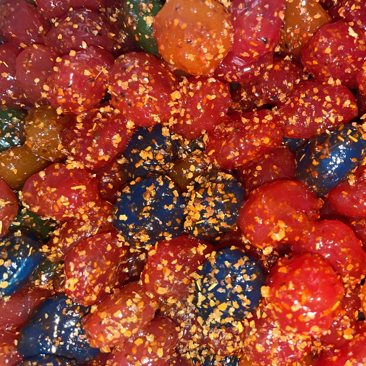 colorful pica pica gushers gummy candies in red, blue, and brown, coated with spicy chili powder and sugar